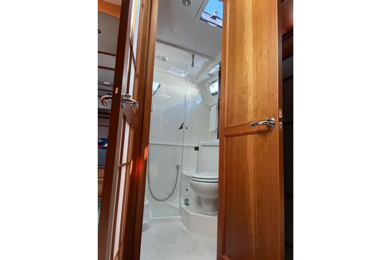 Slide: The Image of Interior of 2023 Sabre 45 Salon Express yacht with wooden door and skylight. - 40