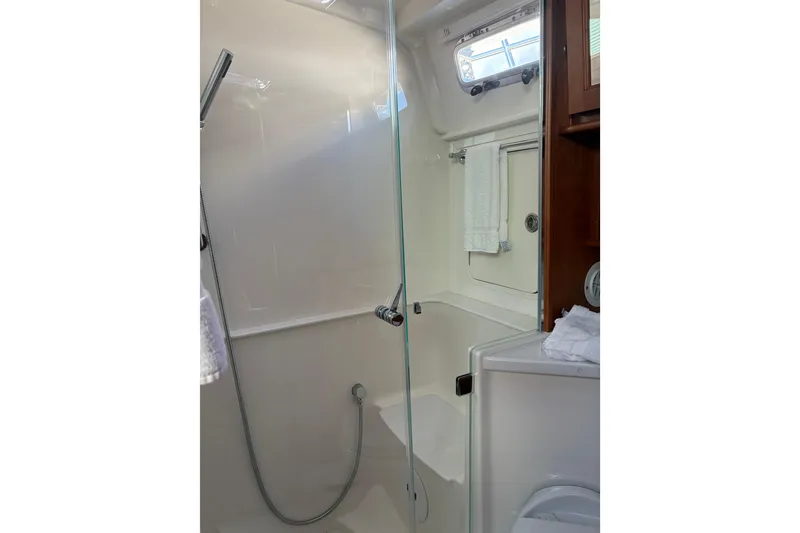 Slide: The Image of 2023 Sabre 45 Salon Express bathroom interior with wooden door and modern fixtures. - 41