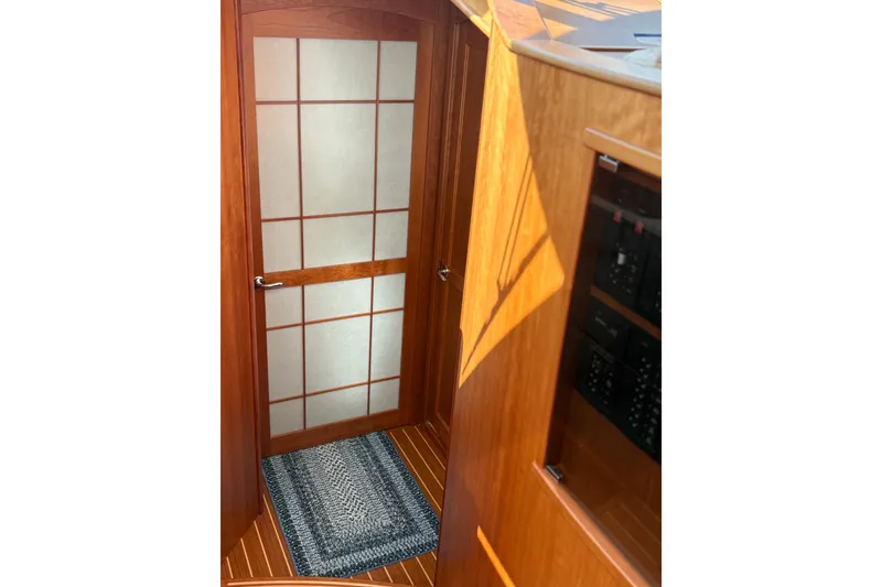 Slide: The Image of Interior of 2023 Sabre 45 Salon Express with elegant wooden door and stairs. - 43