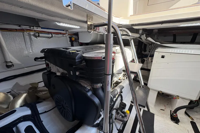 Slide: The Image of Engine room of 2023 Sabre 45 Salon Express, showcasing mechanical components and wiring. - 48