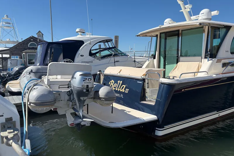 Slide: The Image of 2023 Sabre 45 Salon Express yacht docked with inflatable boat attached. - 57