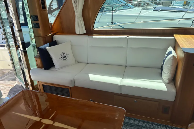 Slide: The Image of Interior of 2023 Sabre 45 Salon Express yacht with white seating and wooden accents. - 7