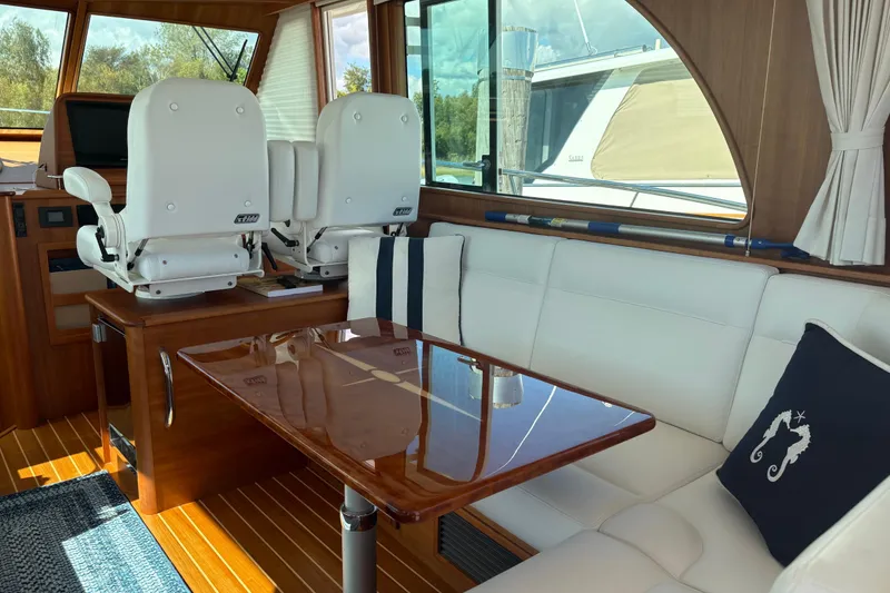 Slide: The Image of Interior of 2023 Sabre 45 Salon Express yacht with white seating and nautical decor. - 8