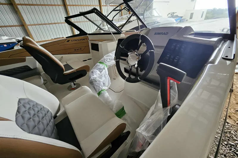 Slide: The Image of 2025 Starcraft SVX 210 OB boat interior with steering wheel and modern dashboard. - 3