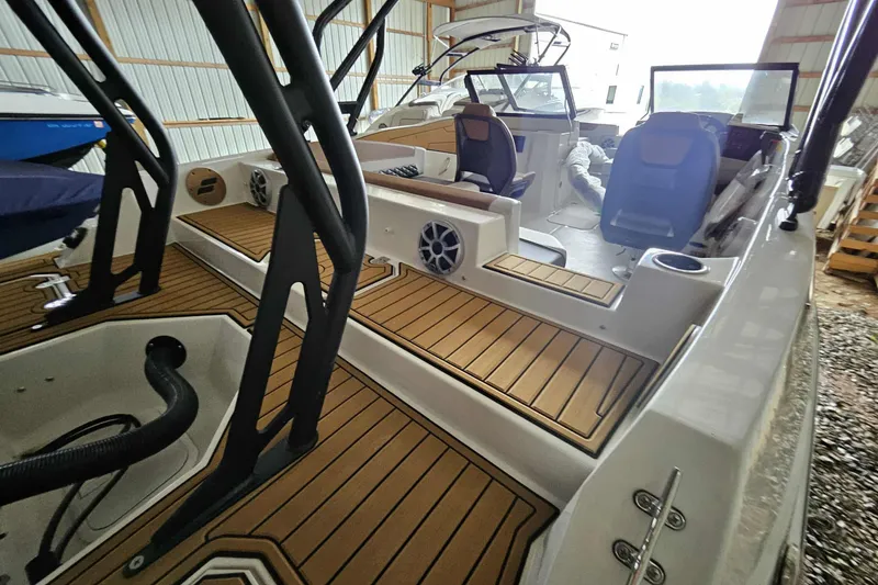 Slide: The Image of 2025 Starcraft SVX 210 OB boat interior with wood flooring and modern seating. - 4