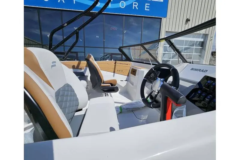 Slide: The Image of 2025 Starcraft SVX 210 OB boat interior with modern steering and seating. - 7