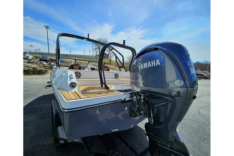 Slide: The Image of 2025 Starcraft SVX 210 OB boat with Yamaha outboard motor, parked outdoors. - 8