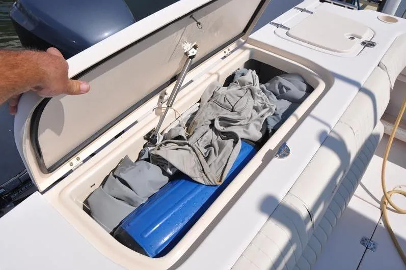 Slide: The Image of Storage compartment on a 2010 Grady-White Chesapeake 290 boat, open with items inside. - 10