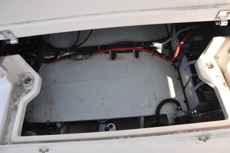 Slide: The Image of 2010 Grady-White Chesapeake 290 boat battery compartment with wiring and components. - 12