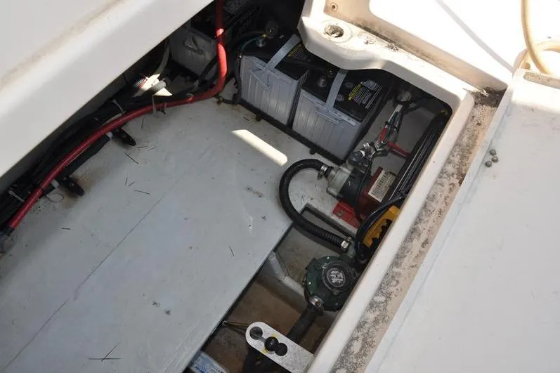 Slide: The Image of 2010 Grady-White Chesapeake 290 boat battery compartment with wiring and components. - 13