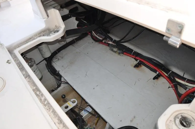Slide: The Image of 2010 Grady-White Chesapeake 290 boat interior wiring and storage compartment. - 14
