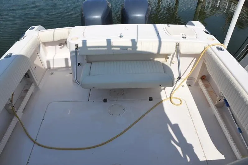 Slide: The Image of 2010 Grady-White Chesapeake 290 boat deck with seating and twin engines. - 15