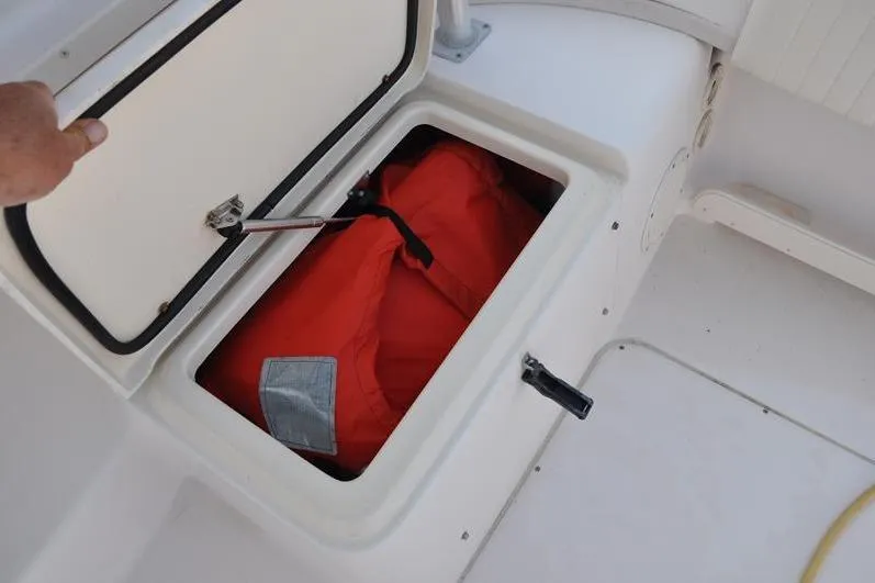 Slide: The Image of Storage compartment on 2010 Grady-White Chesapeake 290 boat with orange life jacket. - 20