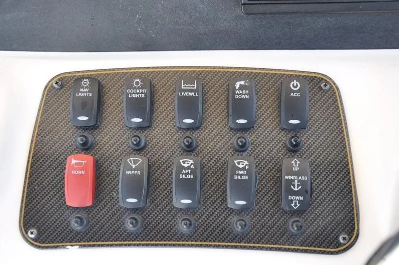 Slide: The Image of Control panel of a 2010 Grady-White Chesapeake 290 boat with labeled switches. - 27