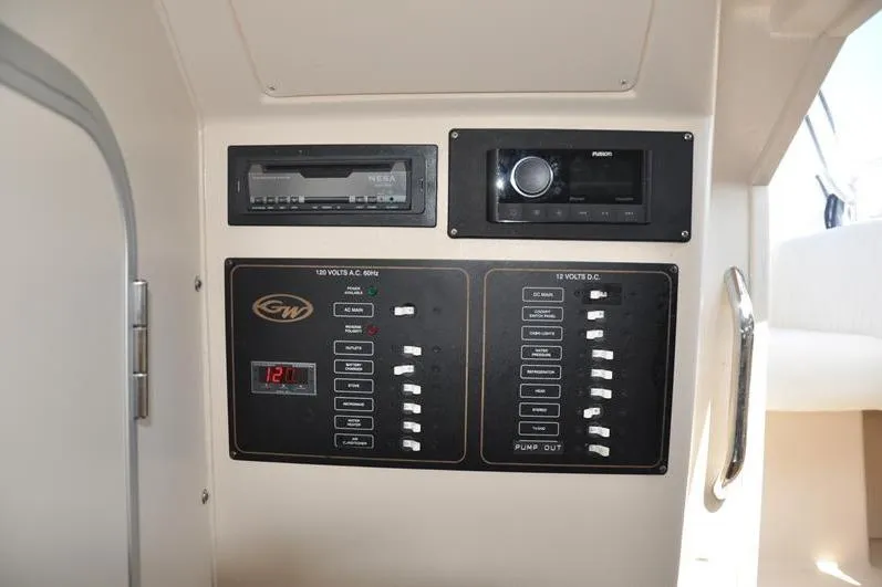 Slide: The Image of Control panel of a 2010 Grady-White Chesapeake 290 boat, featuring electrical switches and displays. - 34