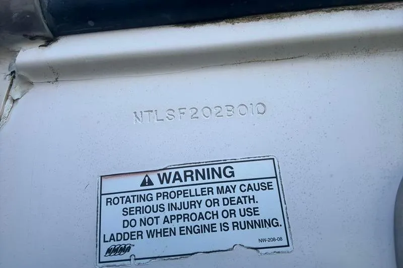 Slide: The Image of Warning label on 2010 Grady-White Chesapeake 290 boat, cautioning about rotating propeller danger. - 40