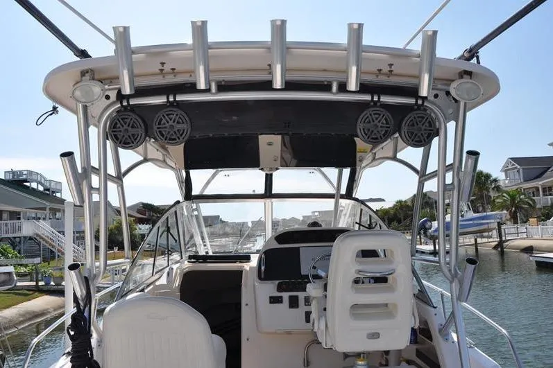 Slide: The Image of 2010 Grady-White Chesapeake 290 boat interior with helm and rod holders. - 5
