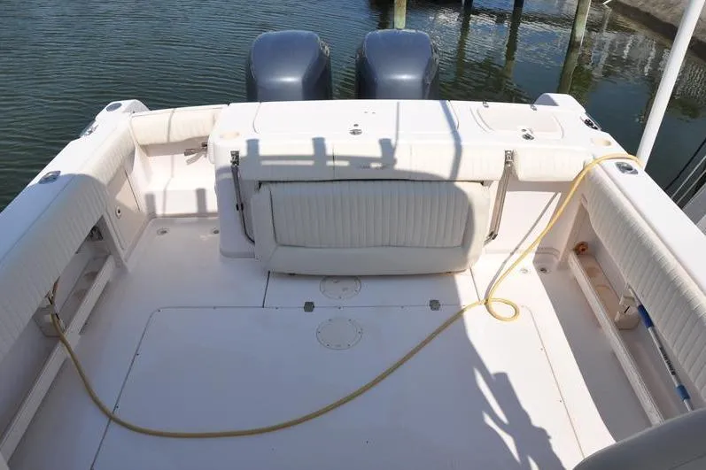 Slide: The Image of 2010 Grady-White Chesapeake 290 boat deck with twin engines and seating area. - 6