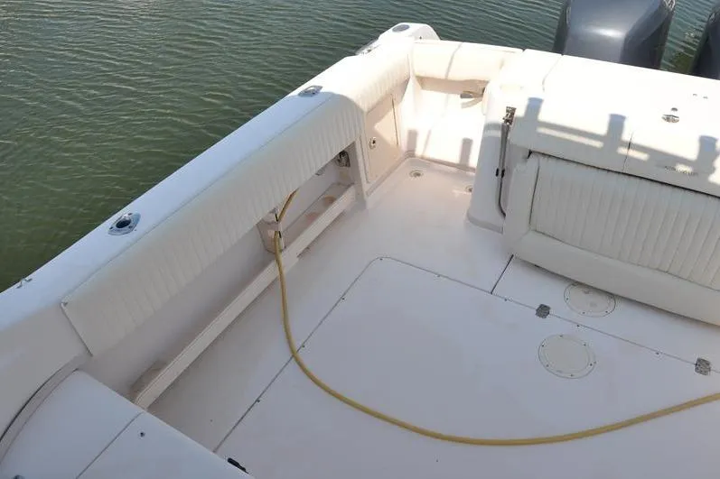 Slide: The Image of 2010 Grady-White Chesapeake 290 boat deck with cushioned seating and clean layout. - 7