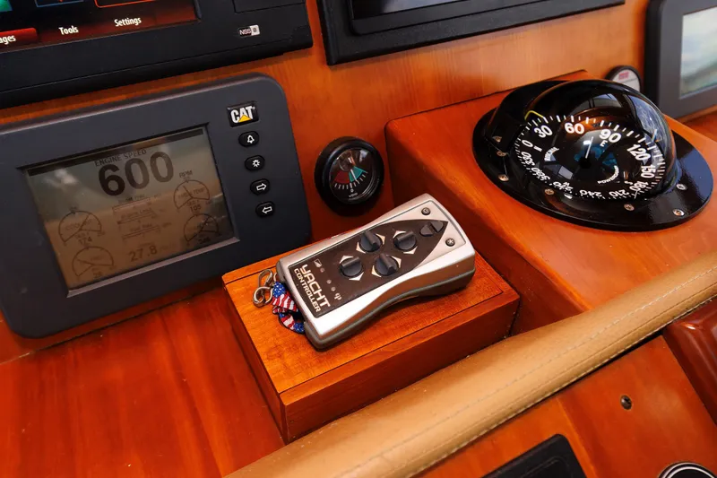 Slide: The Image of Helm of 2009 Hunt Yachts 52 Express with navigation screens and wooden steering wheel. - 33