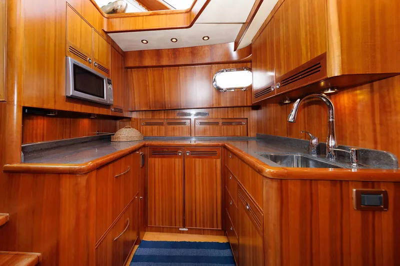 Slide: The Image of Luxurious wooden interior of 2009 Hunt Yachts 52 Express, featuring a modern kitchen. - 35