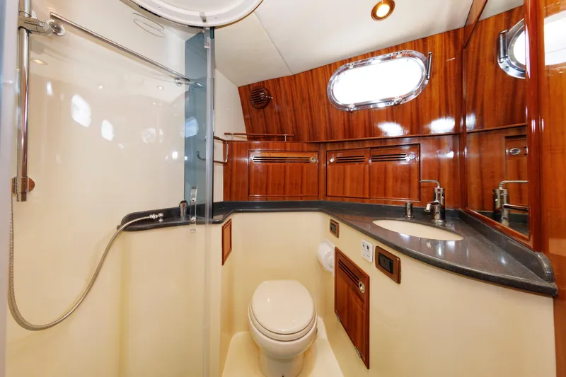 Slide: The Image of Luxurious bathroom in 2009 Hunt Yachts 52 Express, featuring shower and wooden cabinetry. - 41