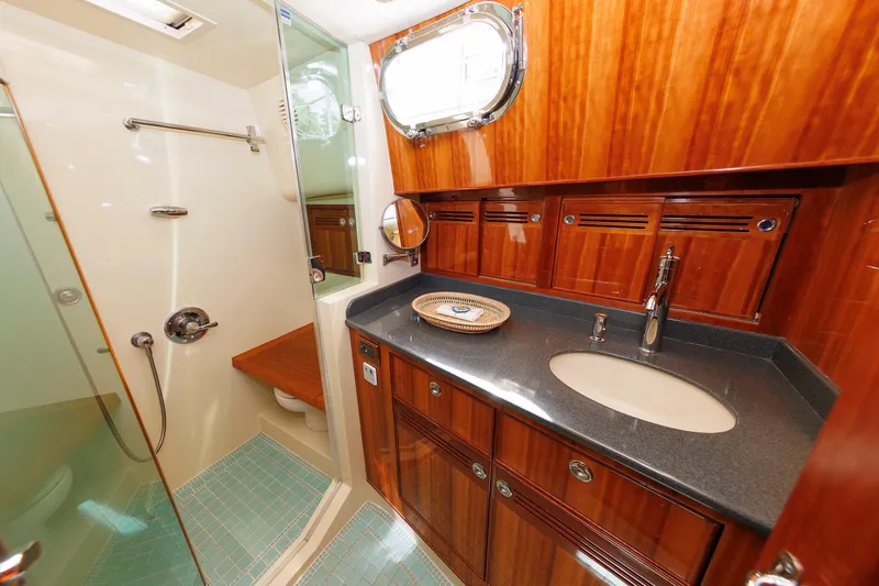 Slide: The Image of Luxurious 2009 Hunt Yachts 52 Express cabin with elegant wood finish and cozy bedding. - 47