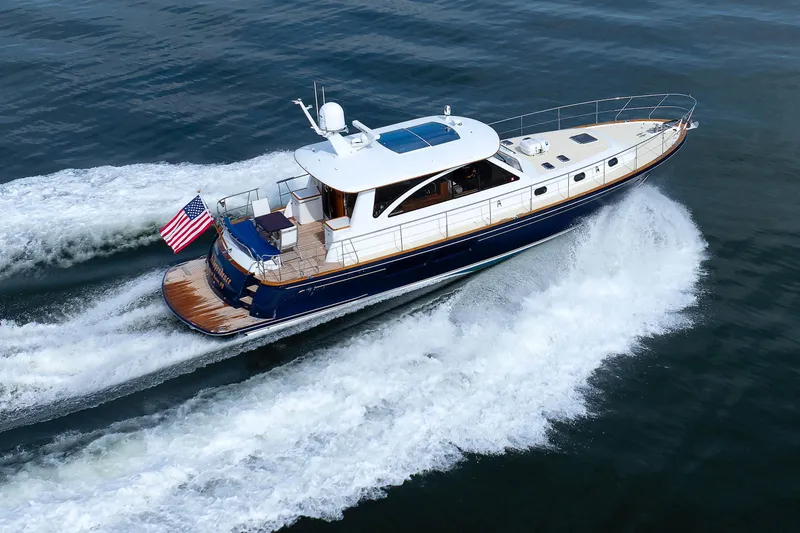 Slide: The Image of 2009 Hunt Yachts 52 Express cruising on calm waters with American flag. - 62
