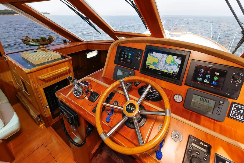 Slide: The Image of Helm of 2009 Hunt Yachts 52 Express with navigation screens and wooden steering wheel. - 32
