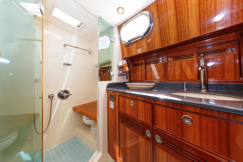 Slide: The Image of Luxurious bathroom in 2009 Hunt Yachts 52 Express, featuring wood accents and modern fixtures. - 42