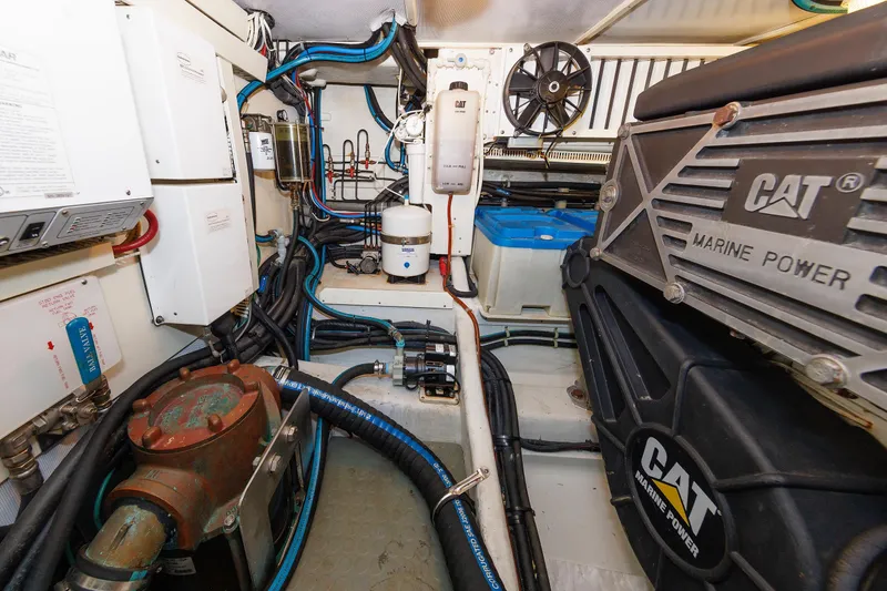 Slide: The Image of Engine room of 2009 Hunt Yachts 52 Express, featuring batteries and fire extinguisher. - 52