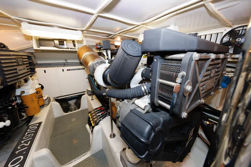 Slide: The Image of Engine room of 2009 Hunt Yachts 52 Express, featuring control panels and wiring. - 55