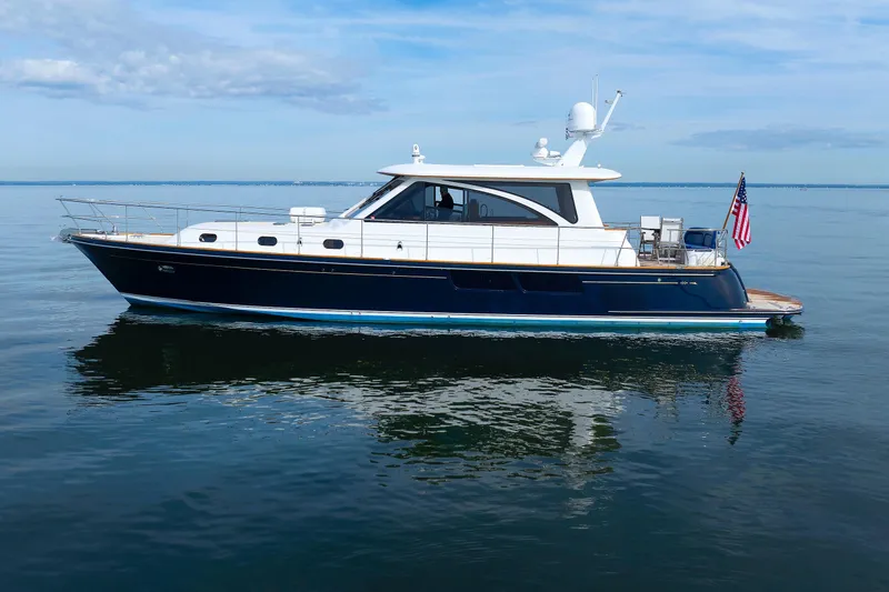 Slide: The Image of 2009 Hunt Yachts 52 Express cruising on open water with American flag. - 7