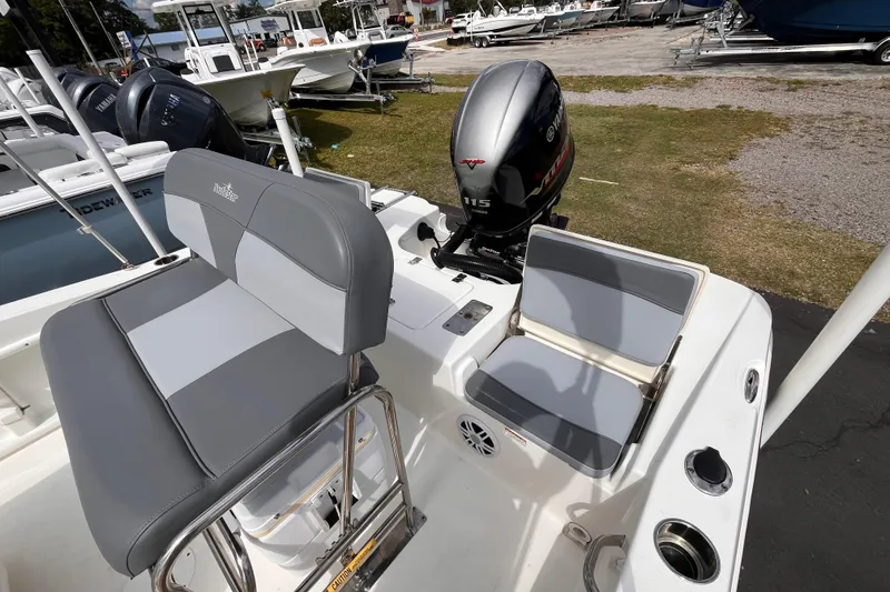 Slide: The Image of 2023 NauticStar 191 Hybrid boat interior with Yamaha 115 engine, featuring gray seating. - 13