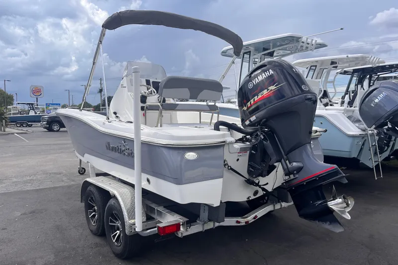 Slide: The Image of 2023 NauticStar 191 Hybrid boat with Yamaha outboard motor on a trailer. - 2