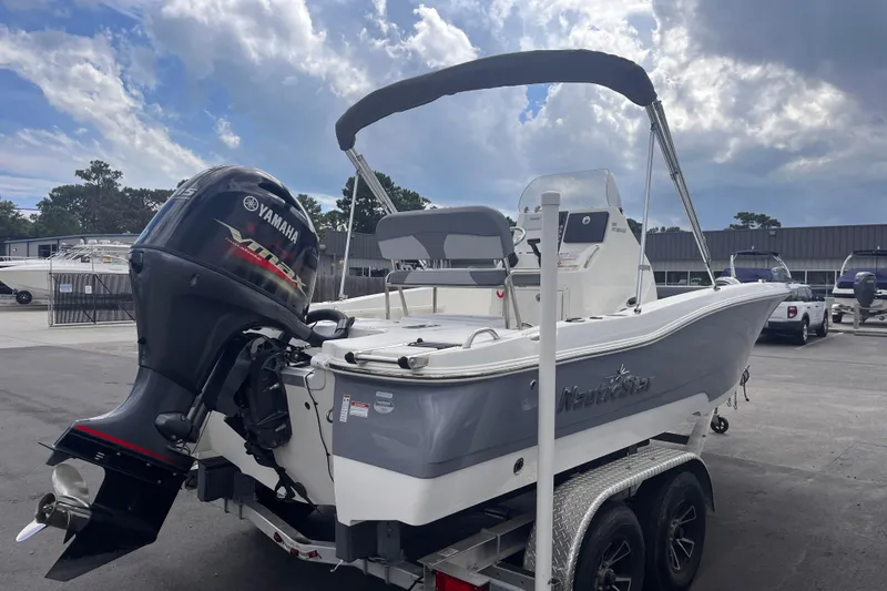 Slide: The Image of 2023 NauticStar 191 Hybrid boat with Yamaha outboard motor on trailer, under cloudy sky. - 4