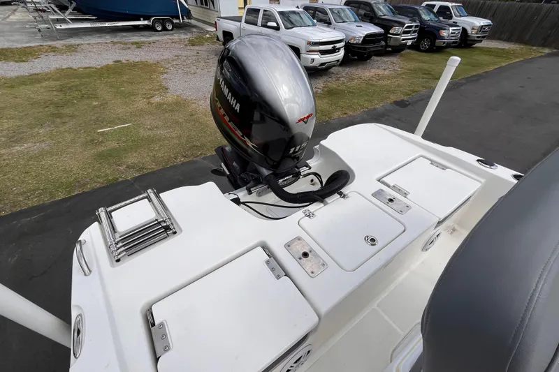 Slide: The Image of 2023 NauticStar 191 Hybrid boat with Yamaha outboard motor, parked near trucks. - 5