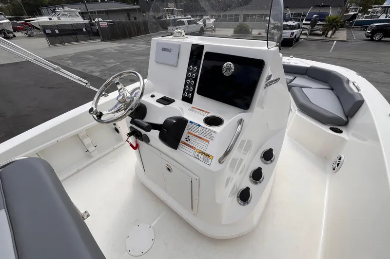 Slide: The Image of 2023 NauticStar 191 Hybrid boat interior with steering console and seating area. - 7