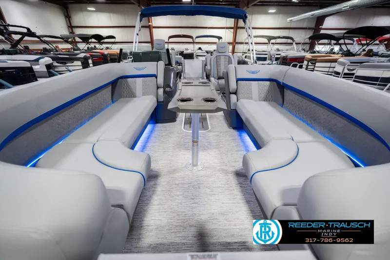 Slide: The Image of Luxurious interior of 2026 Bennington 24 MOFB pontoon boat with blue LED lighting. - 16
