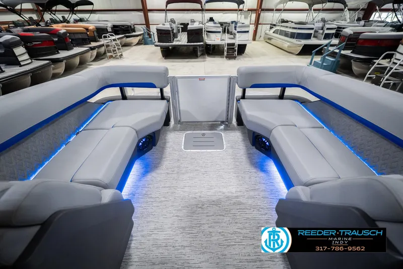 Slide: The Image of 2026 Bennington 24 MOFB pontoon boat interior with blue LED lighting in showroom. - 18