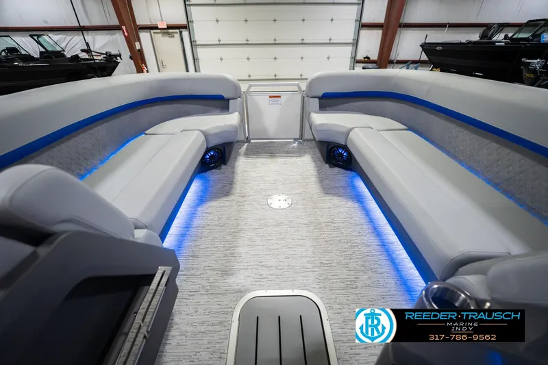 Slide: The Image of 2026 Bennington 24 MOFB boat interior with gray seating and blue LED lighting. - 22