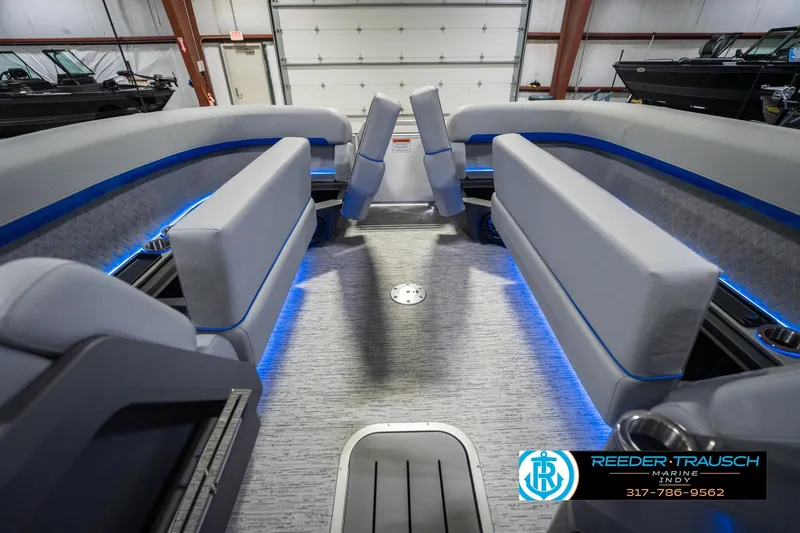Slide: The Image of 2026 Bennington 24 MOFB boat interior with modern seating and blue LED lighting. - 23