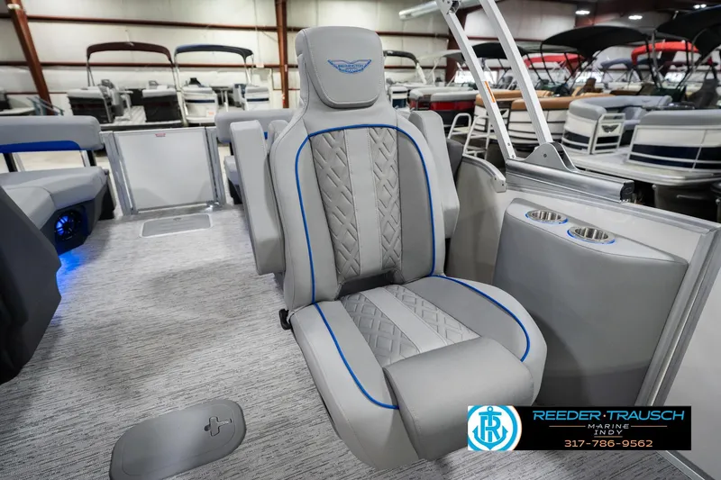 Slide: The Image of 2026 Bennington 24 MOFB boat interior with luxury seating and cup holders in showroom. - 29