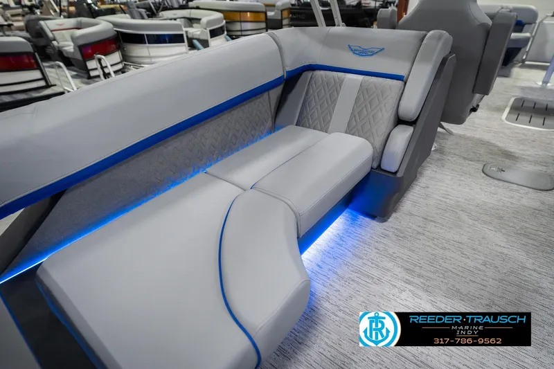 Slide: The Image of Luxurious seating in 2026 Bennington 24 MOFB pontoon boat with blue LED lighting. - 31