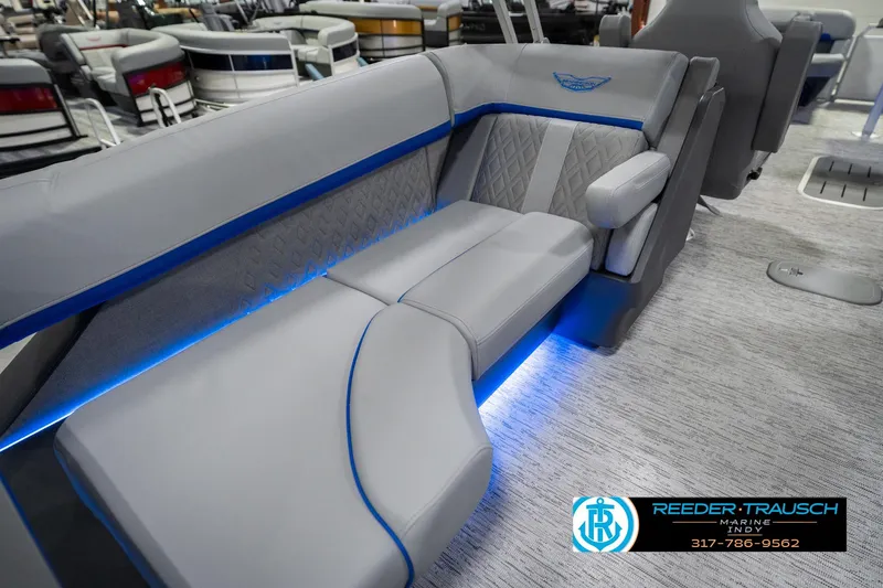 Slide: The Image of 2026 Bennington 24 MOFB boat interior with luxurious gray seating and blue LED lighting. - 32