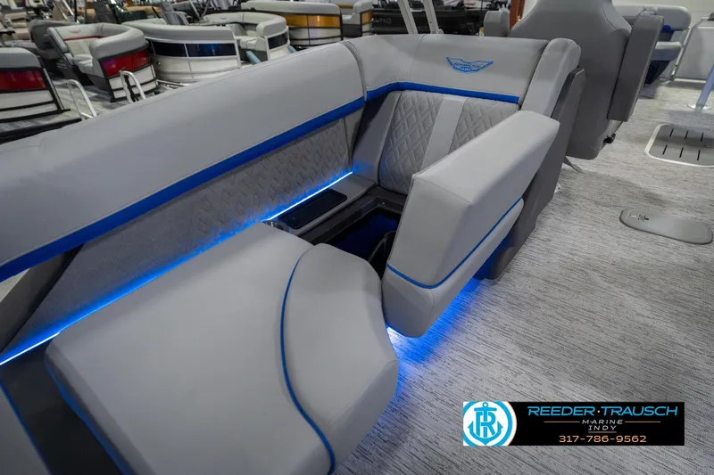 Slide: The Image of 2026 Bennington 24 MOFB boat interior with blue LED lighting and plush seating. - 33