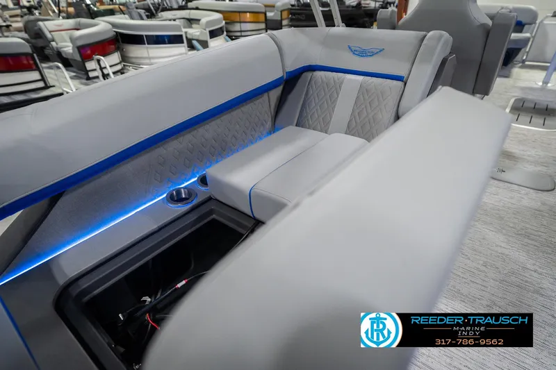 Slide: The Image of 2026 Bennington 24 MOFB boat interior with gray seating and blue LED lighting. - 34