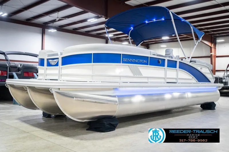 Slide: The Image of 2026 Bennington 24 MOFB pontoon boat with blue canopy in showroom. - 4