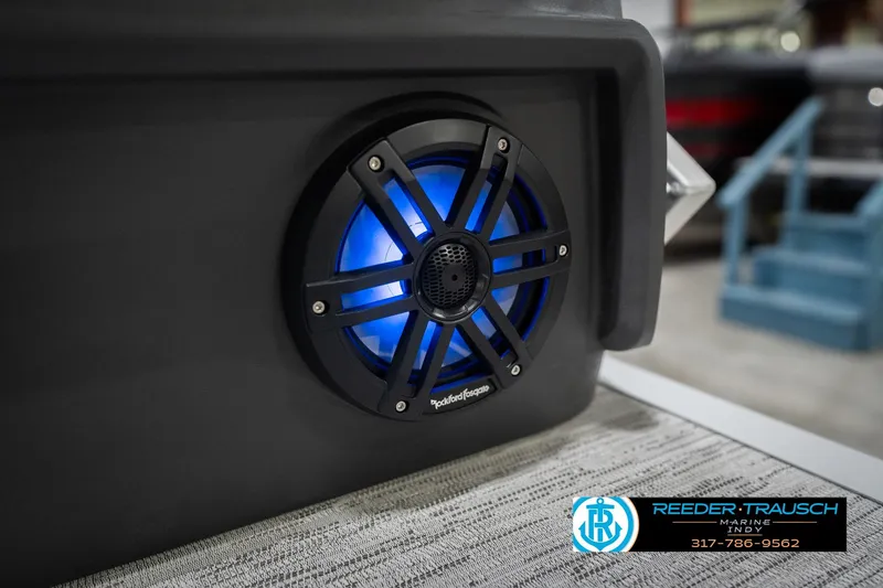 Slide: The Image of 2026 Bennington 24 MOFB boat speaker with blue LED lighting, Reeder-Trausch Marine logo. - 50
