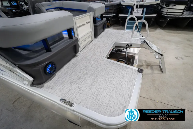 Slide: The Image of 2026 Bennington 24 MOFB pontoon boat with seating and swim ladder, displayed at Reeder-Trausch Marine. - 64